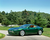AUT 09 RK0199 02
Aston Martin Vantage Green Concept Car 3/4 Side View On Pavement By Grass And Trees Blue Sky