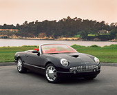 AUT 09 RK0279 10
Ford Thunderbird Convertible Black Concept Car 3/4 Front View On Pavement By Water Red Sky