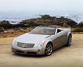 AUT 09 RK0303 03
Cadillac Evoq Convertible Silver Concept Car 3/4 Front View By Rocks And Ocean