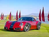 AUT 09 RK1151 01
2010 Devon GTX Concept Red And Black 3/4 Front View On Grass By Ocean