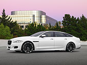 AUT 09 RK1215 01
Jaguar XJ 70 Concept White 3/4 Side View On Pavement By Building And Trees At Dusk