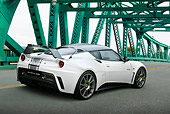 AUT 09 RK1268 01
Lotus Evora GTE Roadcar Concept Silver With Black Stripe 3/4 Rear View On Green Bridge
