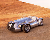 AUT 09 RK0420 05
Special Six Roadster Silver Front 3/4 View On Dirt By Dry Grass Hill