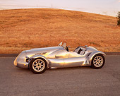 AUT 09 RK0422 01
Special Six Roadster Silver Side 3/4 View On Pavement By Dry Grass Hill