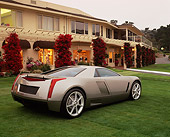 AUT 09 RK0504 01
Cadillac Zien Silver 3/4 Rear View On Grass By Building