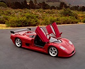 AUT 09 RK0665 03
2003 Mosler MT900S Prototype Rosa Barchetta 3/4 Front View Door Open On Pavement By Bushes