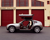 AUT 09 RK0699 03
Infiniti Triant Pewter Concept Car Profile Doors Open On Pavement By Garage Doors