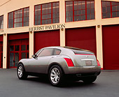 AUT 09 RK0703 01
Infiniti Triant Pewter Concept Car 3/4 Rear View On Pavement By Garage Doors