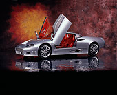 AUT 09 RK0837 06
2006 Spyker C8 Double 12 S Silver 3/4 Side View Doors Open On Mylar Floor Studio
