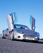 AUT 09 RK0844 02
2006 Spyker C8 Double 12 S Silver Slanted Low 3/4 Front View Doors Open On Pavement Blue Sky