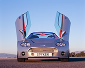 AUT 09 RK0847 03
2006 Spyker C8 Double 12 S Silver Low Head On View Doors Open On Pavement Blue Sky