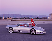 AUT 09 RK0854 01
2006 Spyker C8 Double 12 S Silver 3/4 Side View Door Open On Pavement At Dusk