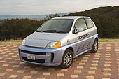 AUT 09 RK0868 01
Honda FCX Fuel Cell Car Silver 3/4 Front View By Trees