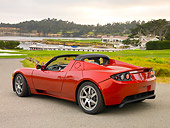 AUT 09 RK0884 01
Tesla Roadster Electric Car Red 3/4 Rear View On Pavement By Grass And Trees