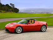 AUT 09 RK0886 01
Tesla Roadster Electric Car Red 3/4 Side View On Pavement By Grass And Trees