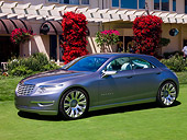 AUT 09 RK1020 01
Chrysler Nassau Concept Silver 3/4 Front View On Grass By Building Shrubs