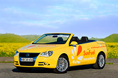 AUT 09 RK1032 01
Volkswagen Eos SunFuel Prototype Yellow 3/4 Front View On Pavement By Hills Sky