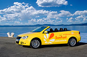 AUT 09 RK1035 01
Volkswagen Eos SunFuel Prototype Yellow 3/4 Front View On Pavement By Water Sky