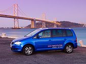 AUT 09 RK1037 01
Volkswagen Touran HyMotion Concept Blue 3/4 Front View On Pavement By Bridge Water Hills Sky