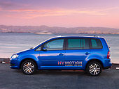 AUT 09 RK1039 01
Volkswagen Touran HyMotion Prototype Blue Profile View On Pavement By Water Hills Sky