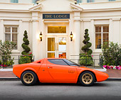 AUT 09 RK1064 01
1970 Lancia Stratos HF Prototype Bertone Coupe DayGlo Red Profile View On Pavement By Mansion