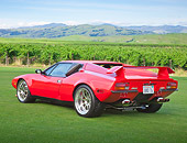 AUT 10 RK0038 01
1974 De Tomaso Pantera Red 3/4 Rear View On Grass By Vineyard