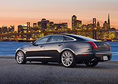 AUT 12 BK0011 01
2012 Jaguar XJF Black 3/4 Rear View On Pavement By Bay Bridge At Sunset
