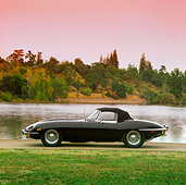 AUT 12 RK0024 03
1969 Black Jaguar XKE Conv Side View By Lake And Grass At Dusk