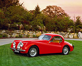 AUT 12 RK0152 02
1954 Jaguar XK120 FHC Red Side 3/4 Side View On Grass By Trees
