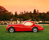 AUT 12 RK0153 01
1954 Jaguar XK120 FHC Red Profile On Grass By Trees Filtered