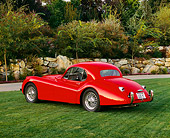 AUT 12 RK0154 05
1954 Jaguar XK120 FHC Red Rear 3/4 View On Grass By Trees