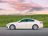 AUT 12 RK0331 01
2010 Jaguar XFR White Profile On Pavement By Grassy Hill