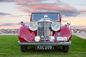 AUT 12 RK0368 01
1948 Jaguar Mark IV Drophead Coupe Red Head On View On Grass At Dusk