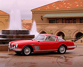 AUT 12 RK0054 05
1958 Red Jaguar Ghia Coupe XK140 3/4 Side View On Wet Pavement By Water Fountain
