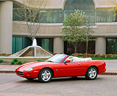 AUT 12 RK0065 03
1999 Jaguar XK8 Convertible Phoenix Red 3/4 Side View On Pavement By Building And Fountain
