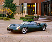 AUT 12 RK0077 02
1966 Jaguar XJ13 Recreation Convertible Green 3/4 Side View In Front Of Museum Headlights On