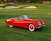 AUT 12 RK0086 05
1951 Jaguar XK120 Roadster Red 3/4 Front View On Grass