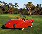 AUT 12 RK0087 02
1951 Jaguar XK120 Roadster Red 3/4 Rear View On Grass Trees Background