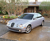 AUT 12 RK0102 01
2001 Jaguar Type S Silver Front 3/4 View On Wet Pavement By House And Trees