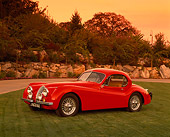 AUT 12 RK0152 03
1954 Jaguar XK120 FHC Red Side 3/4 Side View On Grass By Trees