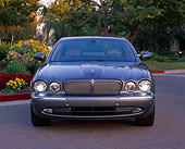 AUT 12 RK0171 02
2004 Jaguar XJR Gray Head On View By Flowers And Trees
