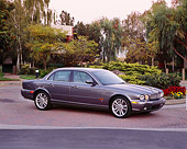 AUT 12 RK0173 03
2004 Jaguar XJR Gray 3/4 Side View On Pavement By Flowers And Trees