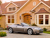 AUT 12 RK0290 01
2009 Jaguar XKR Convertible Gray 3/4 Front View On Driveway By House