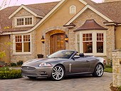 AUT 12 RK0292 01
2009 Jaguar XKR Convertible Gray 3/4 Front View On Driveway By House