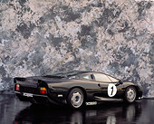 AUT 13 RK0026 11
Jaguar XJ220 Racing Car Black 3/4 Rear View On Black Floor Gray Marble Background Studio