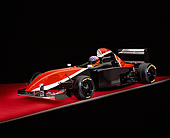 AUT 13 RK0160 01
2006 Mazda Pro Formula Race Car With Driver Black Orange And White Front 3/4 View On Red Floor Studio