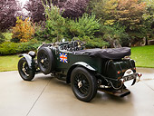 AUT 13 RK0204 01
1929 Bentley Birkin Team Car Dark Green Rear 3/4 View On Pavement By Grass Trees