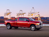 AUT 14 BK0057 01
2010 Dodge Ram 3500 Pickup Truck Red 3/4 Side View On Pavement By Shipping Yard At Dusk
