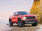 AUT 14 BK0060 01
2011 Ford F-150 SVT Raptor Pickup Truck Red 3/4 Front View On Beach By Cliffs