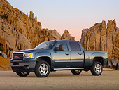 AUT 14 BK0065 01
2011 GMC Sierra Pickup Truck Blue 3/4 Side View On Gravel By Red Rocks